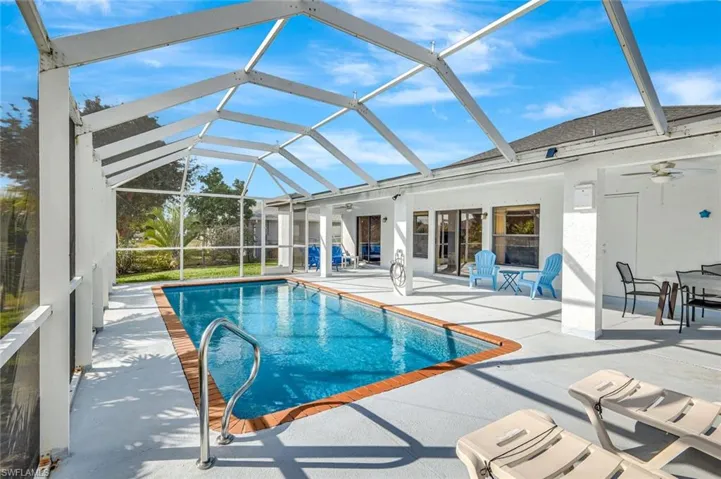 Swimming pool with a lanai, a patio area, and a sunroom