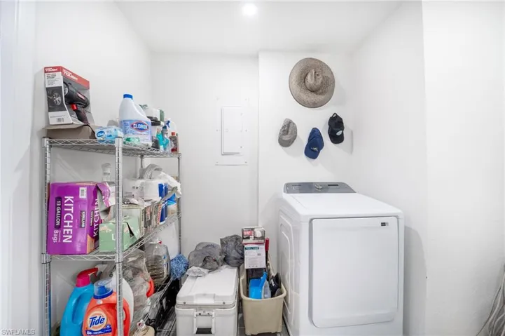Laundry area with electric panel and washing machine and clothes dryer