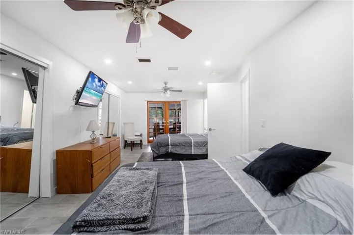 Bedroom featuring french doors and ceiling fan