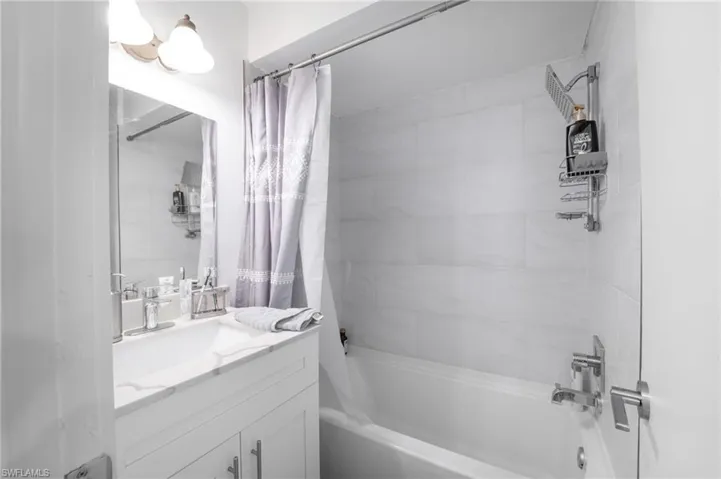 Bathroom with vanity and shower / tub combo with curtain