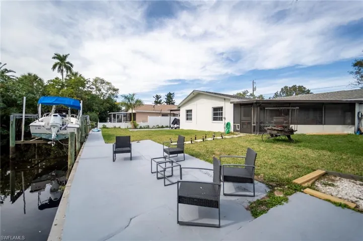 View of patio featuring a sunroom and a boat dock