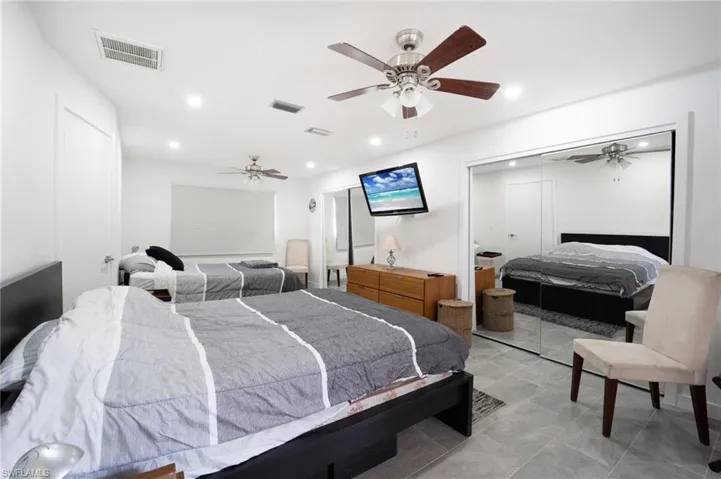 Tiled bedroom with ceiling fan
