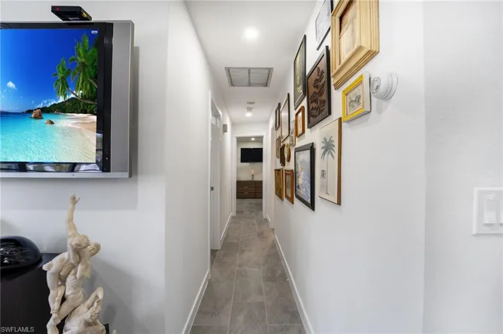 Hall featuring tile patterned floors