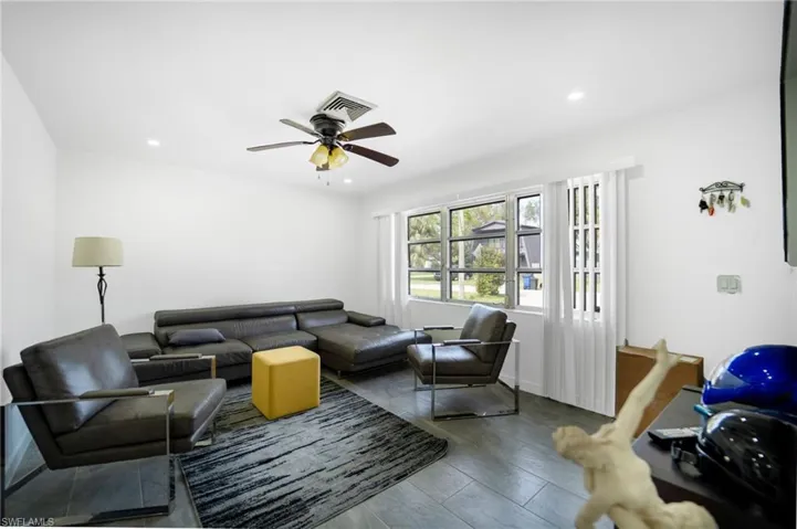 Living room featuring hardwood / wood-style flooring and ceiling fan