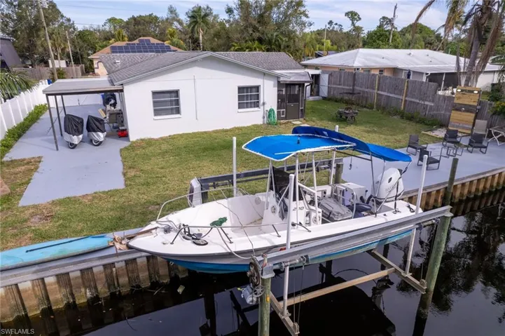 Dock area with a water view and a lawn