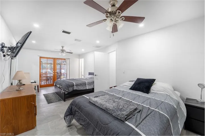 Bedroom with ceiling fan and french doors
