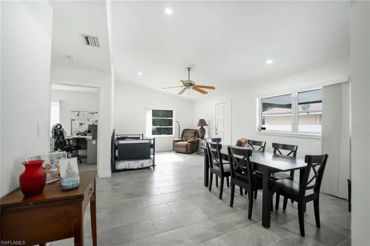 Dining room featuring ceiling fan and vaulted ceiling