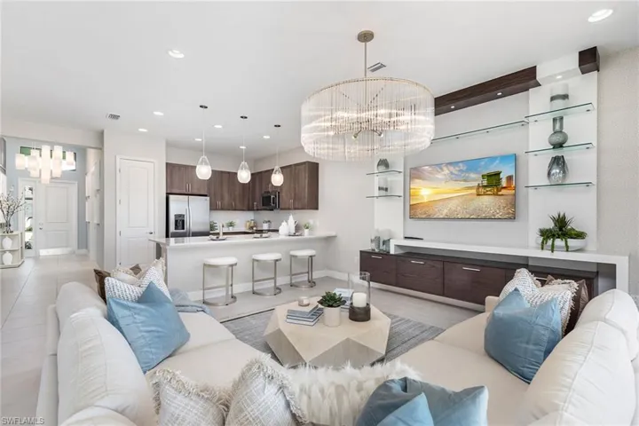 Tiled living room with a notable chandelier