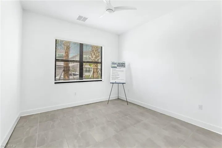 Spare room with ceiling fan