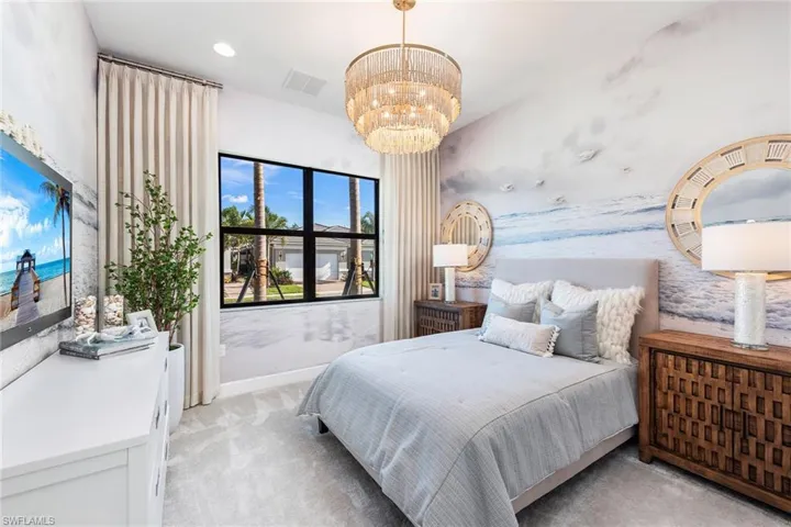 Carpeted bedroom featuring an inviting chandelier