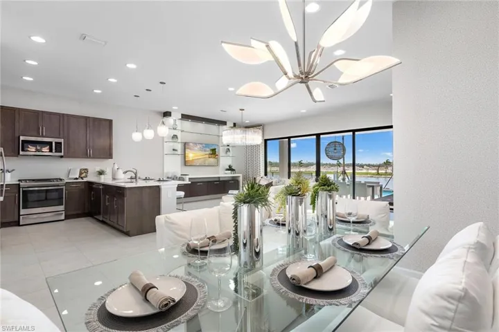 Tiled dining room with a chandelier and sink