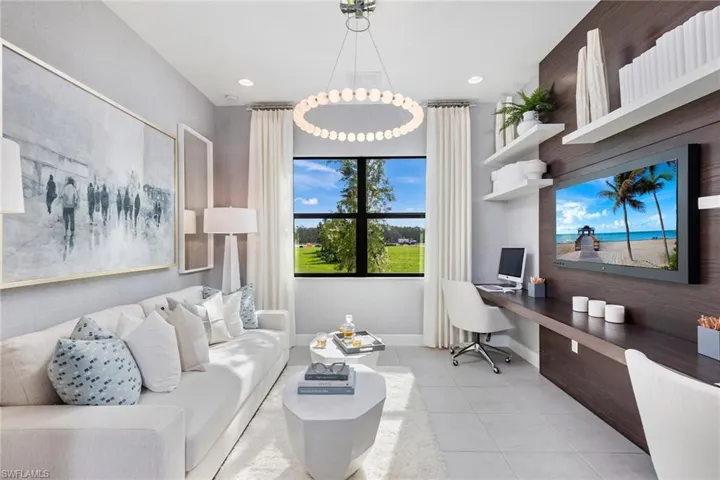Office area with an inviting chandelier, built in desk, and light tile patterned floors