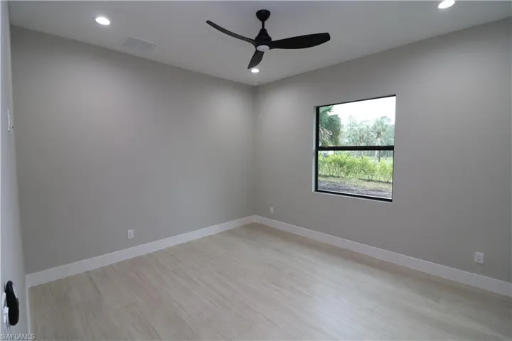 Empty room featuring ceiling fan and light wood-type flooring