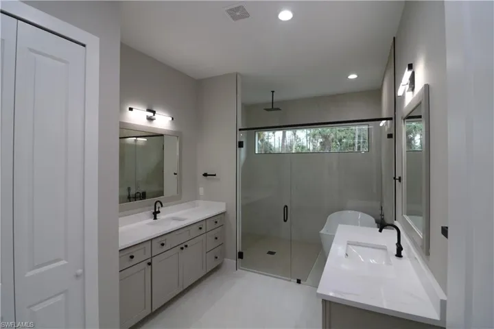 Bathroom with vanity and plus walk in shower