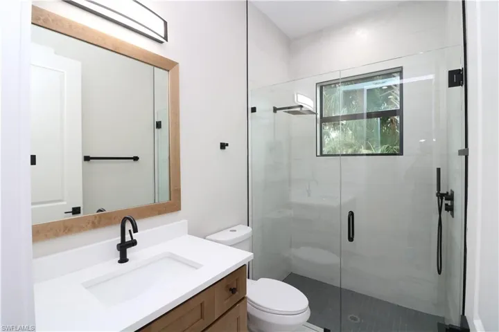 Bathroom with vanity, toilet, and walk in shower