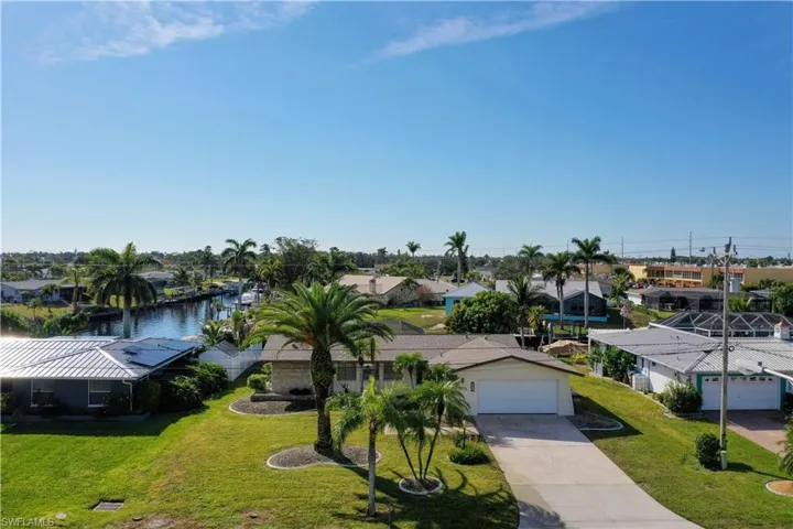 Birds eye view of property with a water view