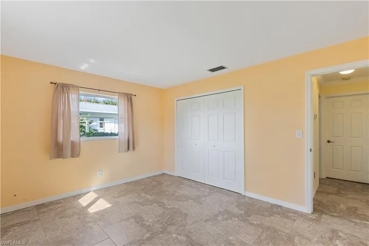 Unfurnished bedroom with a closet