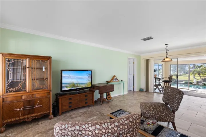 Living room featuring crown molding