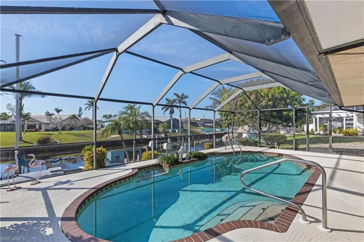 View of swimming pool with a patio and a lanai