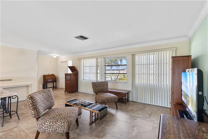 Sitting room featuring crown molding