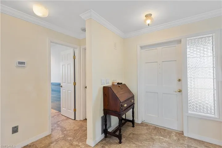 Entryway featuring ornamental molding