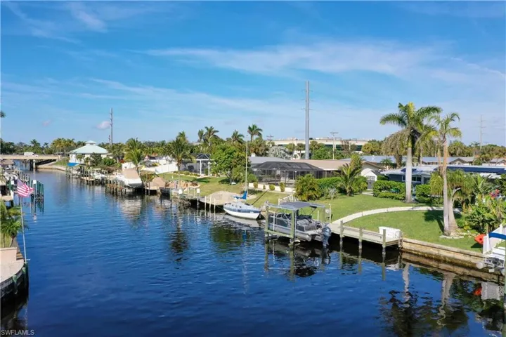 View of dock featuring a yard and a water view