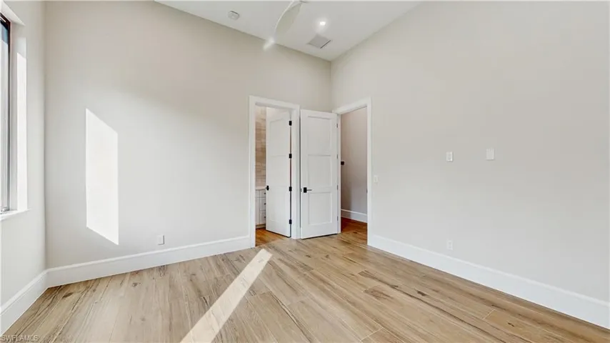 Empty room with light hardwood / wood-style floors