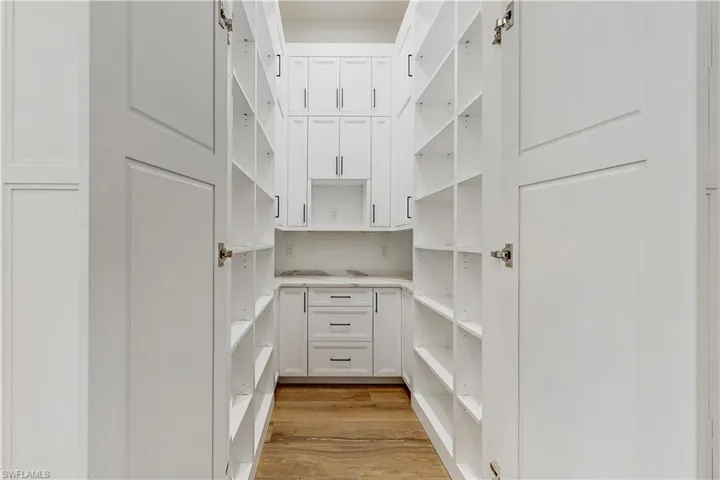 Spacious closet with light hardwood / wood-style floors