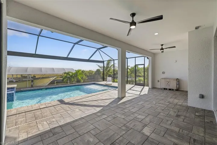 Outdoor pool with a sunroom, a lanai, and a patio
