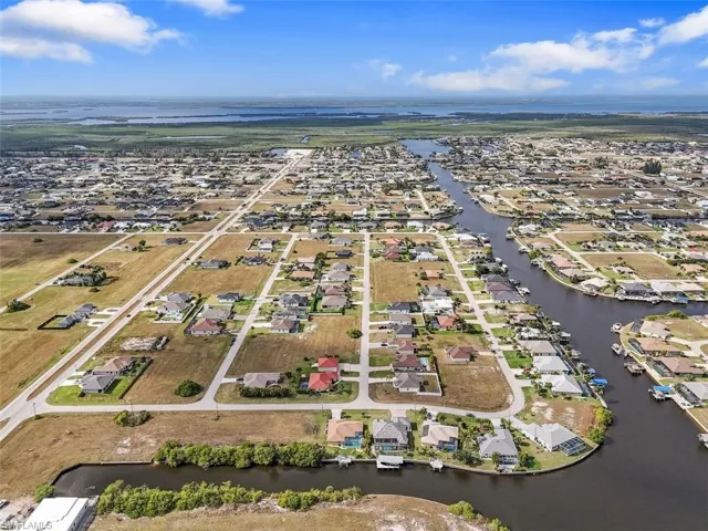 Aerial perspective of suburban area with a large body of water