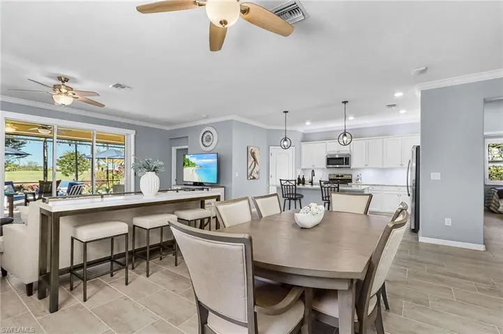 Dining space with ornamental molding, ceiling fan, recessed lighting, and wood finish floors