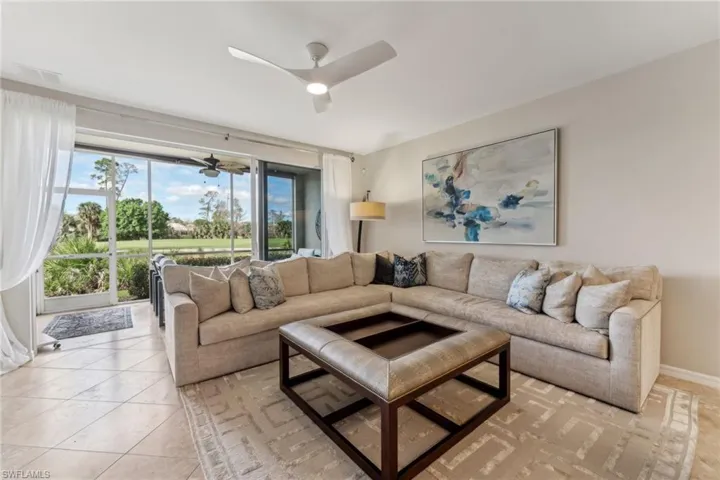 Living area featuring a ceiling fan, visible vents, and light tile patterned floors