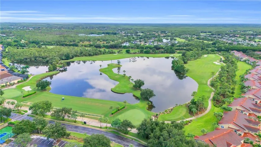 Aerial view with golf course view and a water view