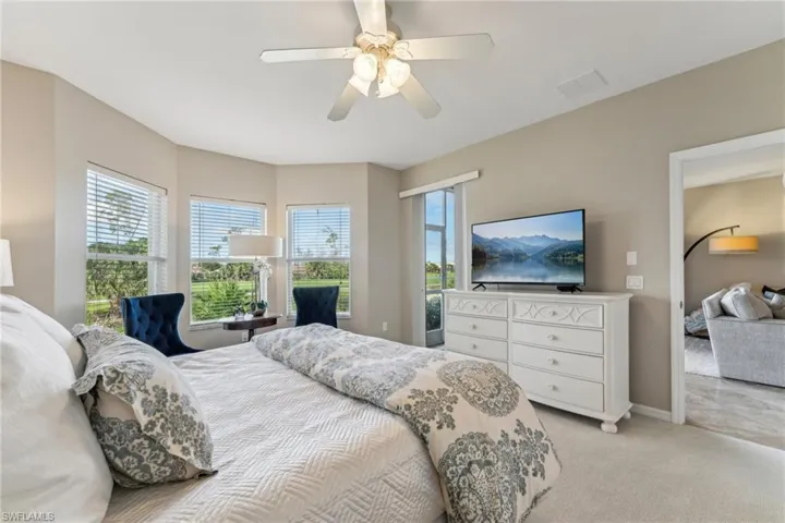 Bedroom featuring baseboards, visible vents, a ceiling fan, and light colored carpet