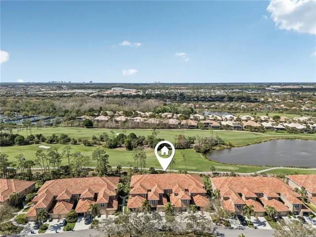 Aerial view with a water view, view of golf course, and a residential view