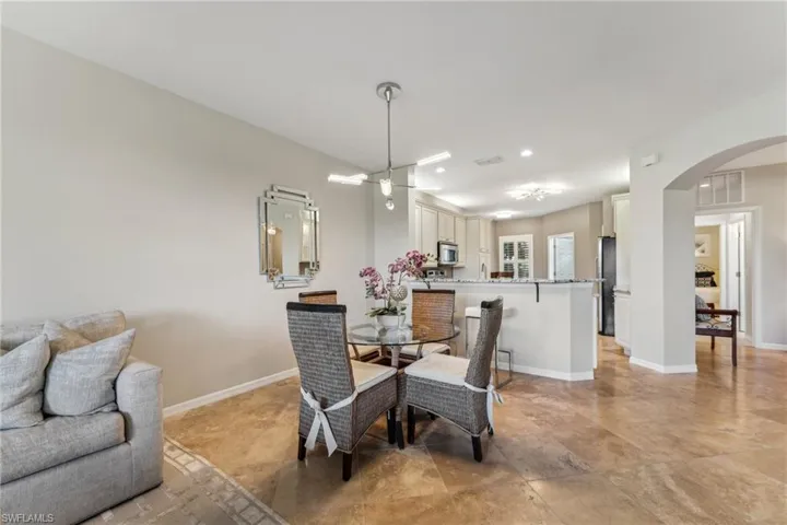 Dining room featuring visible vents, arched walkways, baseboards, and recessed lighting