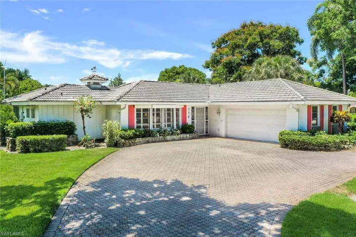 The paver driveway graciously flows from the front side of the property on Anchor Rode Dr to the side exit onto Regatta Rd