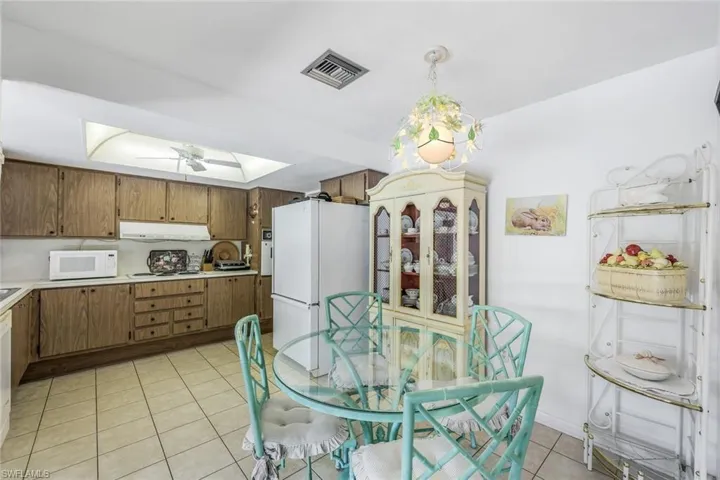 Eat-in kitchen opening directly onto the screened lanai and pool
