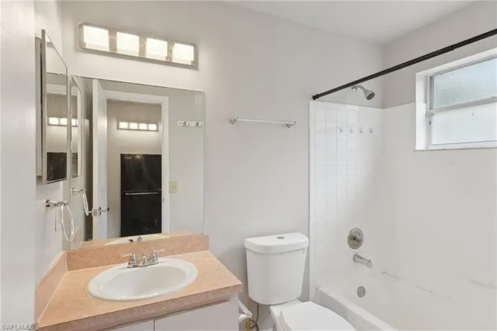 Full bathroom with vanity, toilet, and tiled shower / bath
