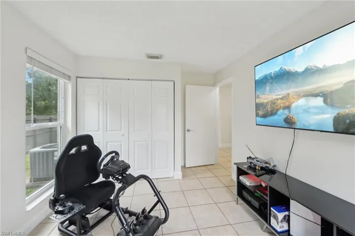 Exercise area featuring plenty of natural light and light tile patterned floors