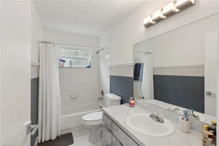 Full bathroom featuring shower / bath combo, toilet, and vanity