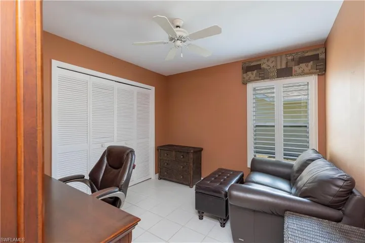 Tiled office space featuring ceiling fan