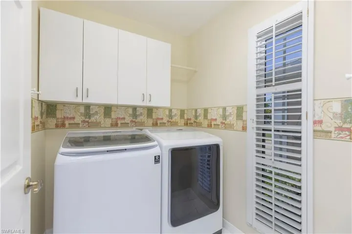 Laundry room featuring washer and dryer and cabinets