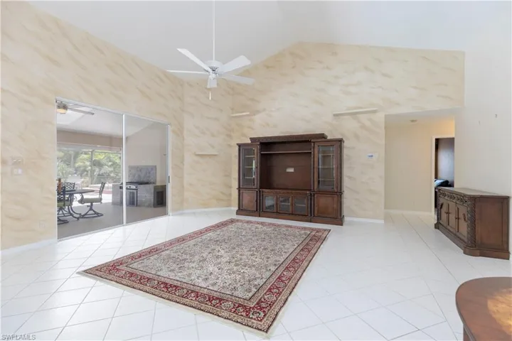 Entryway featuring high vaulted ceiling, ceiling fan, and light tile floors