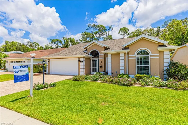 Single story home featuring a garage and a front yard