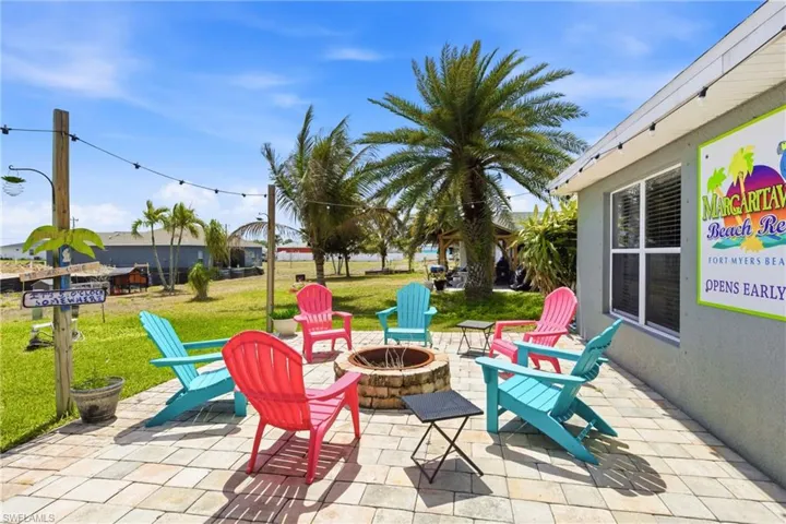 Entertain in style with a tiki bar, outdoor kitchen, and fire pit.