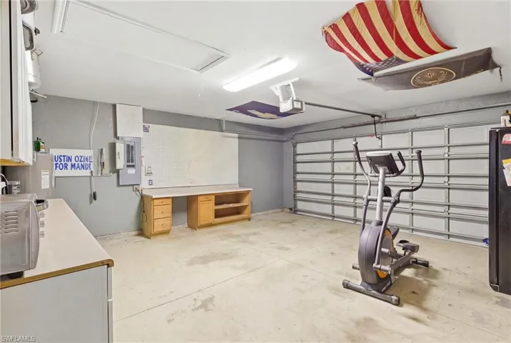 A massive garage designed for both vehicles and storage, complete with built-in cabinets to keep everything organized.
