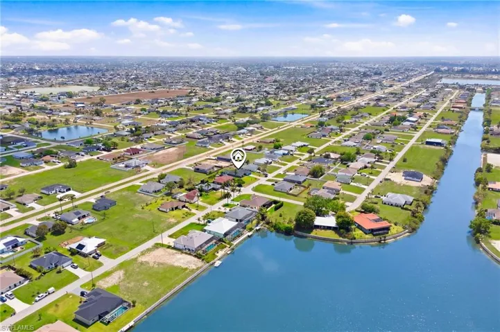 A picture-perfect aerial capturing the harmony between indoor living and outdoor entertaining spaces.