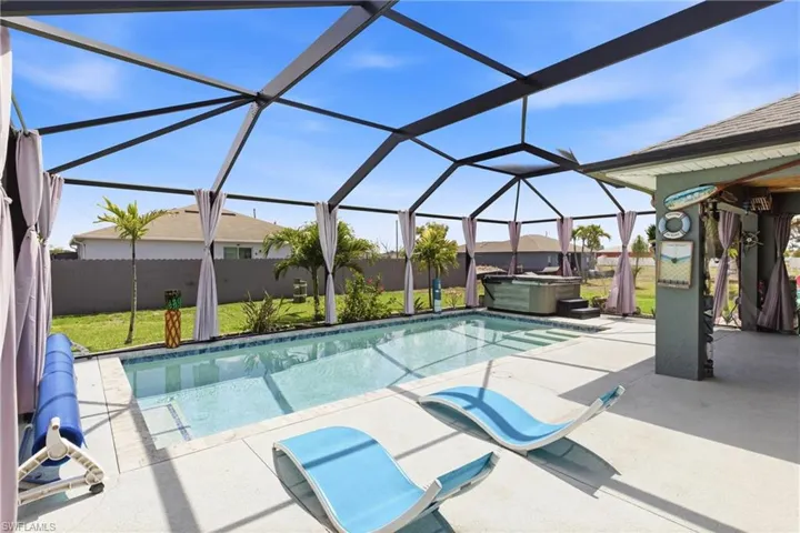 Dive into Florida living with this stunning screened-in pool area.