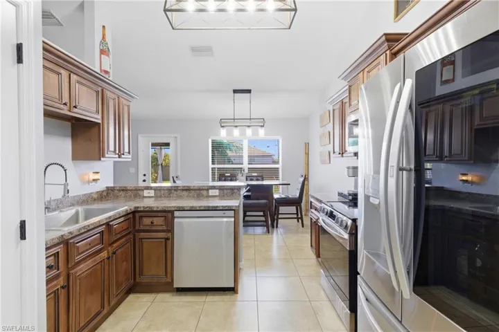 A spacious kitchen designed for gathering, complete with sleek stainless-steel appliances.